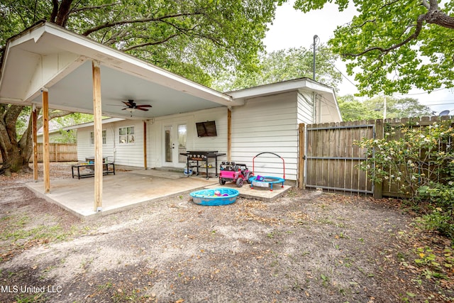 view of patio featuring french doors, fence, and a ceiling fan
