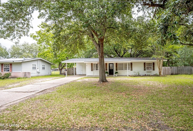 ranch-style home with fence, an attached carport, concrete driveway, and a front yard
