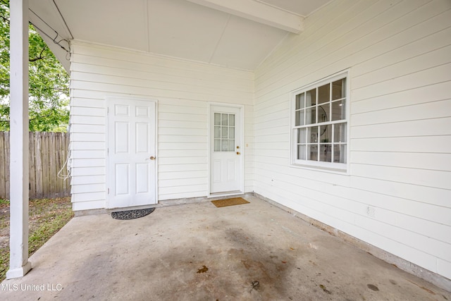 doorway to property featuring a patio area and fence