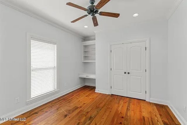 434 Laural Ct, Madison, MS 39110 - unfurnished bedroom with crown molding, wood finished floors, baseboards, recessed lighting, and a closet