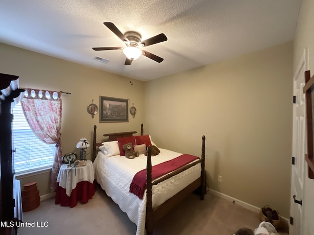 carpeted bedroom with a textured ceiling and ceiling fan