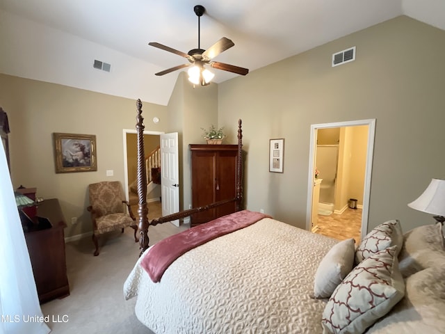 bedroom with light carpet, ensuite bath, vaulted ceiling, and ceiling fan