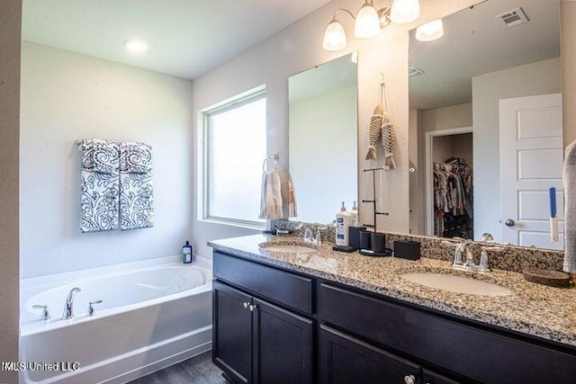 bathroom featuring vanity and a bathtub