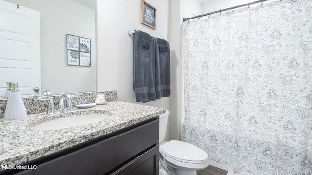 bathroom featuring vanity and toilet