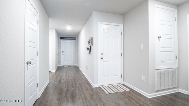 corridor with dark hardwood / wood-style flooring