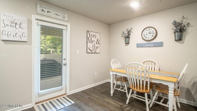 dining space with dark hardwood / wood-style floors