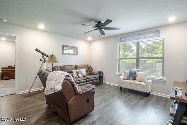 living room featuring dark hardwood / wood-style floors and ceiling fan