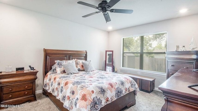 bedroom with light carpet and ceiling fan