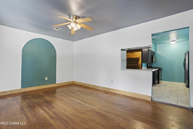 1278 Lopez Pl, Biloxi, MS 39530 - unfurnished living room featuring a ceiling fan, arched walkways, and light wood finished floors