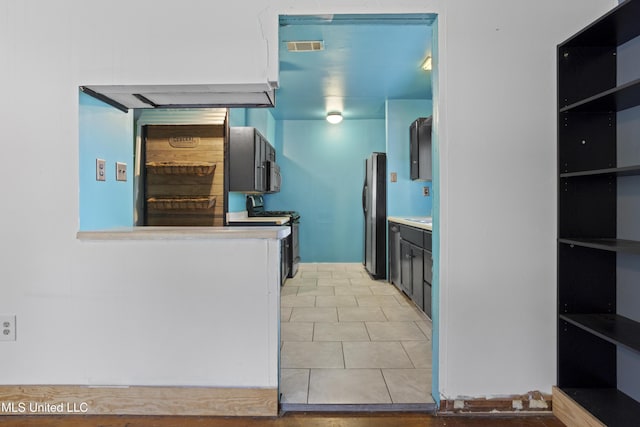 1278 Lopez Pl, Biloxi, MS 39530 - kitchen with stainless steel appliances, light tile patterned flooring, and light countertops