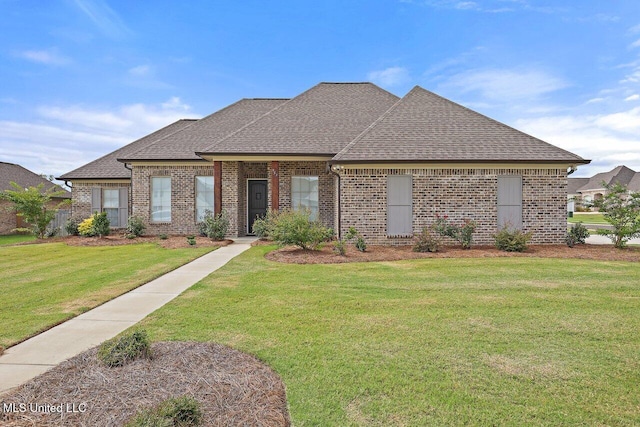 953 Glenwild Cir, Canton, MS 39046 - french country style house featuring brick siding, a shingled roof, and a front yard