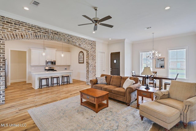 953 Glenwild Cir, Canton, MS 39046 - living area with light wood finished floors, a ceiling fan, ornamental molding, recessed lighting, and a chandelier