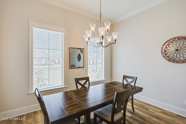 953 Glenwild Cir, Canton, MS 39046 - dining area featuring a chandelier, ornamental molding, and wood finished floors