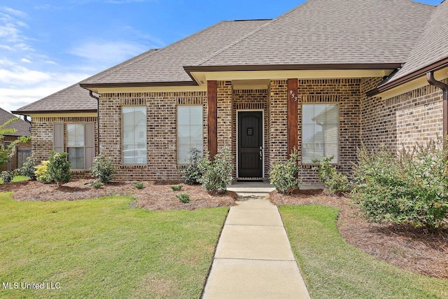 953 Glenwild Cir, Canton, MS 39046 - view of front facade featuring brick siding, a front lawn, and roof with shingles