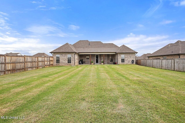 953 Glenwild Cir, Canton, MS 39046 - rear view of property featuring a fenced backyard, brick siding, and a shingled roof