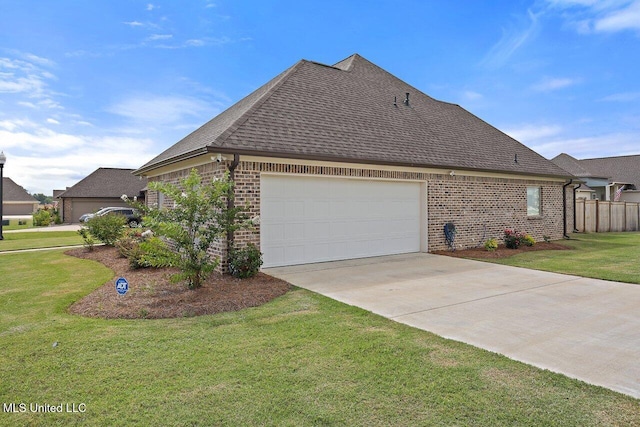 953 Glenwild Cir, Canton, MS 39046 - view of home's exterior with brick siding, roof with shingles, a garage, and concrete driveway