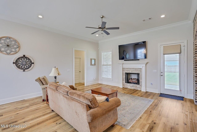953 Glenwild Cir, Canton, MS 39046 - living room with a fireplace, a ceiling fan, ornamental molding, light wood-style floors, and recessed lighting