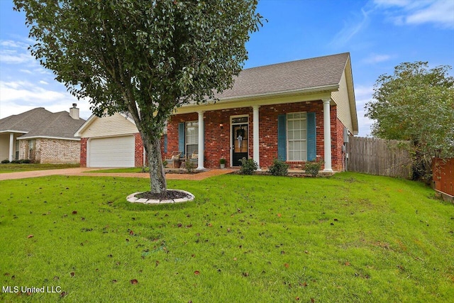 view of front of house with covered porch, a garage, and a front lawn