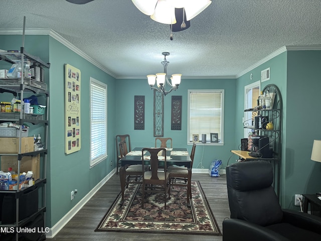 8528 E Cedar Cir, Southaven, MS 38671 - dining area with a textured ceiling, dark wood finished floors, a chandelier, crown molding, and a ceiling fan
