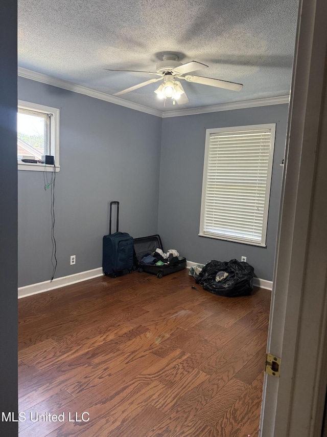 8528 E Cedar Cir, Southaven, MS 38671 - empty room with dark wood-type flooring, a ceiling fan, ornamental molding, and a textured ceiling