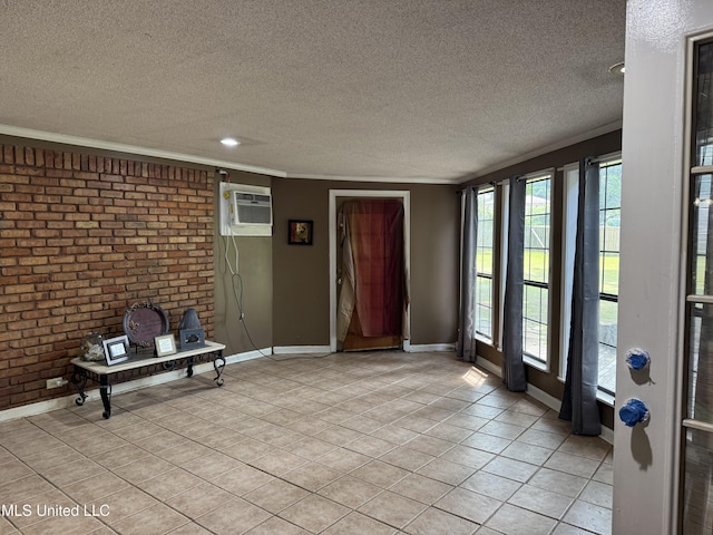 8528 E Cedar Cir, Southaven, MS 38671 - foyer entrance with a wall mounted AC, a textured ceiling, light tile patterned floors, and brick wall
