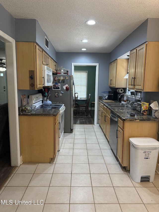 8528 E Cedar Cir, Southaven, MS 38671 - kitchen with stainless steel appliances, a textured ceiling, light tile patterned flooring, and recessed lighting
