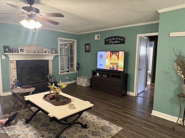 8528 E Cedar Cir, Southaven, MS 38671 - living area with a textured ceiling, dark wood-style floors, ceiling fan, ornamental molding, and a tile fireplace