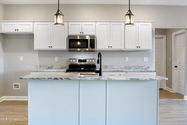 kitchen featuring pendant lighting, light hardwood / wood-style floors, white cabinetry, and stainless steel appliances