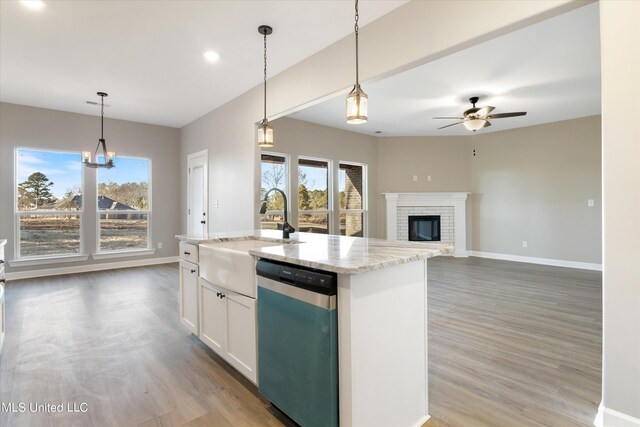 kitchen featuring dishwasher, plenty of natural light, an island with sink, and decorative light fixtures