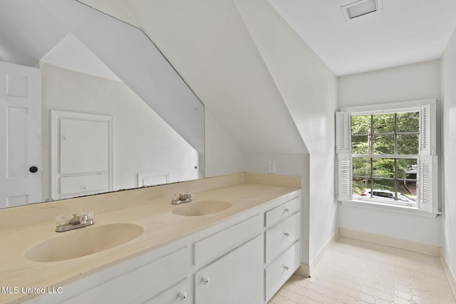 1757 Hillview Dr, Jackson, MS 39211 - bathroom with double vanity, tile patterned floors, and vaulted ceiling