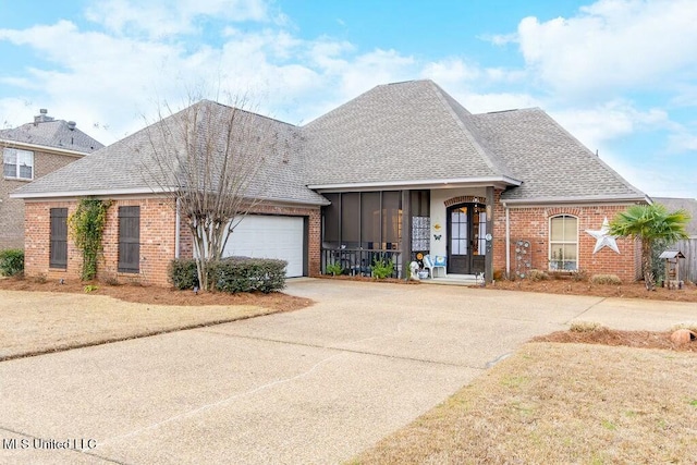 view of front of property featuring a garage, concrete driveway, brick siding, and a shingled roof