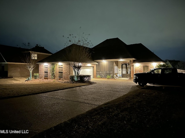 view of front facade featuring brick siding and an attached garage