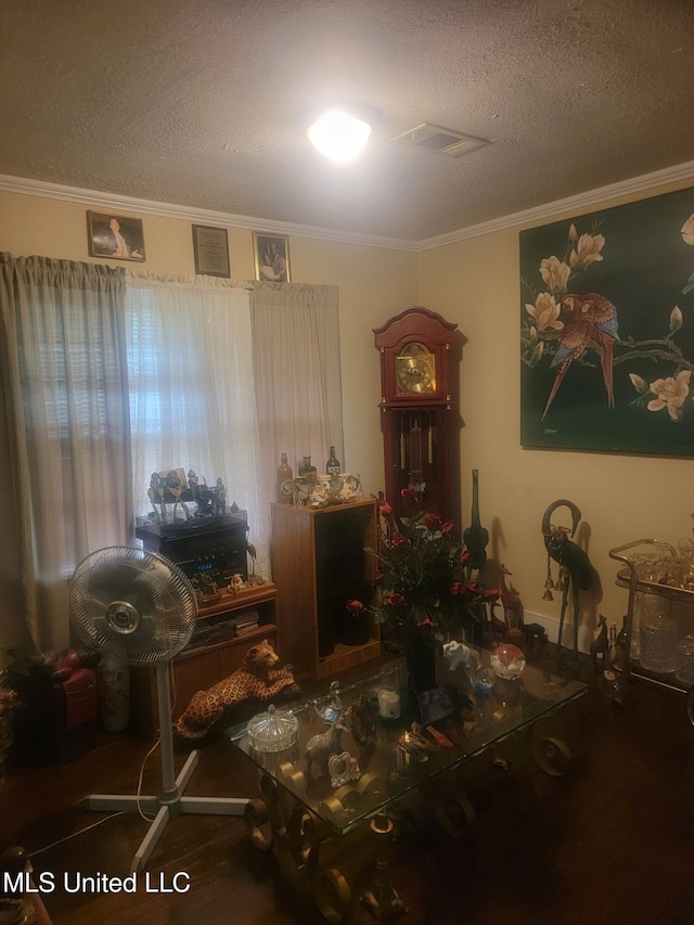3215 Charleston Dr, Jackson, MS 39212 - dining room featuring a textured ceiling, baseboards, ornamental molding, visible vents, and wood finished floors