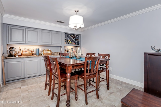 dining area featuring crown molding and a notable chandelier