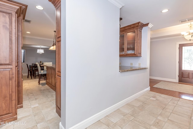 interior space with crown molding and a chandelier