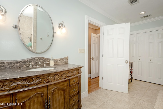 bathroom featuring vanity and crown molding