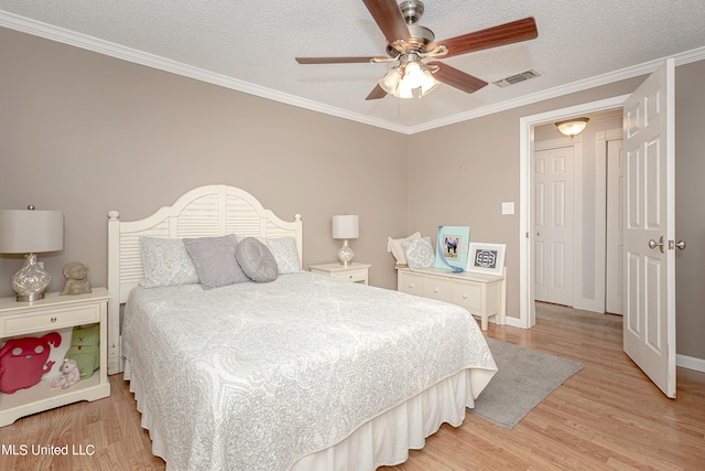 bedroom with light hardwood / wood-style floors, crown molding, a textured ceiling, and ceiling fan