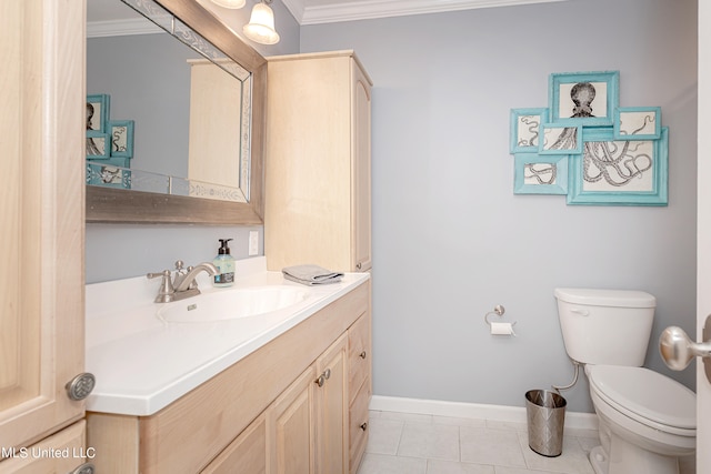 bathroom with vanity, toilet, crown molding, and tile patterned floors