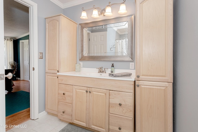 bathroom with vanity, ornamental molding, and hardwood / wood-style floors