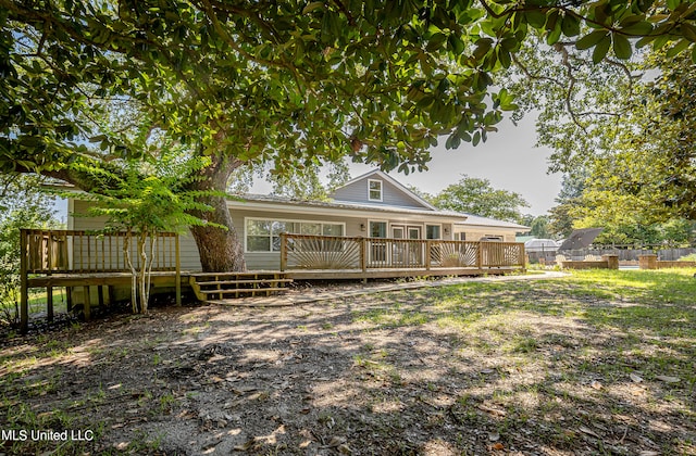 back of property with a wooden deck