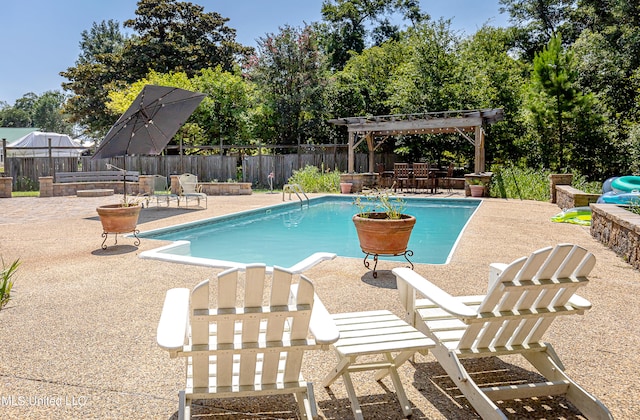 view of swimming pool with a patio area and a pergola