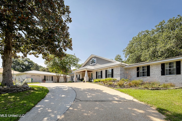 view of front of home with a garage and a front lawn