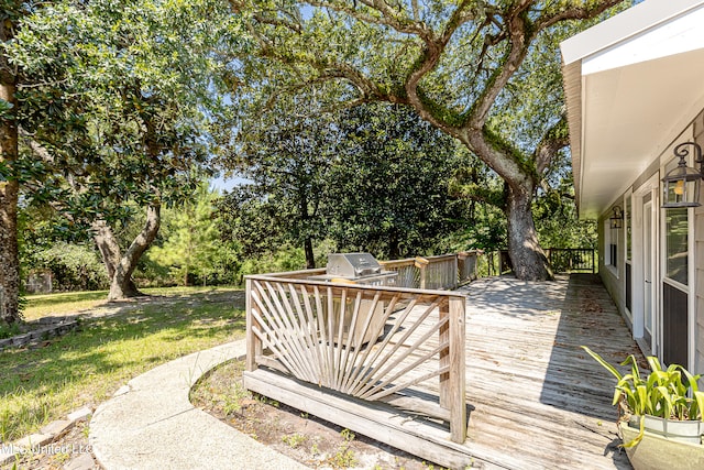 wooden deck with a lawn