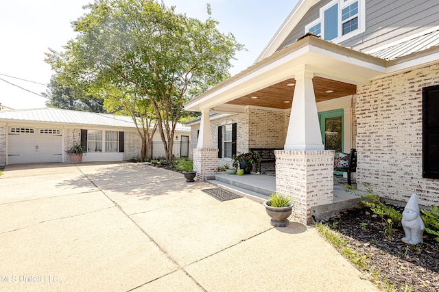 view of patio with covered porch and a garage