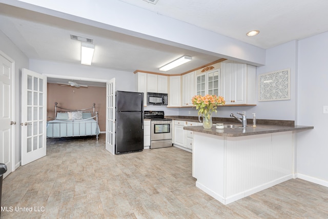 kitchen featuring black appliances, sink, kitchen peninsula, white cabinetry, and light hardwood / wood-style flooring