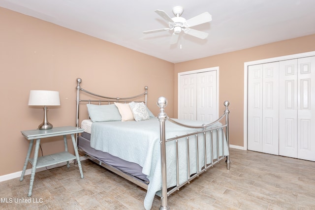 bedroom featuring multiple closets and ceiling fan