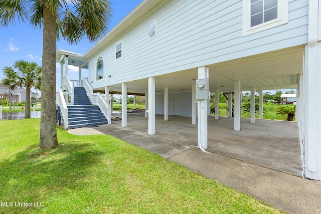 view of patio featuring a water view and a carport