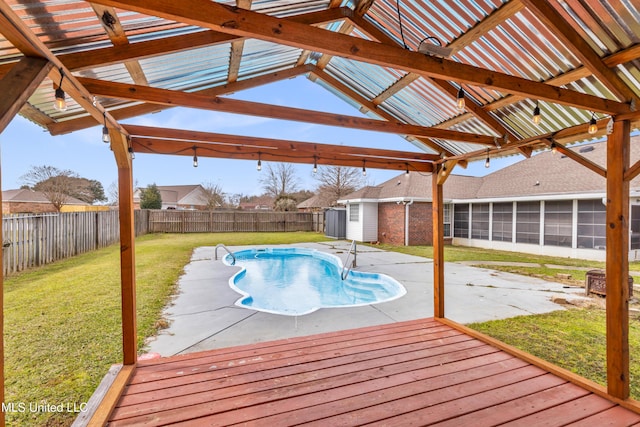 view of swimming pool featuring a fenced in pool, a sunroom, a fenced backyard, a yard, and a patio