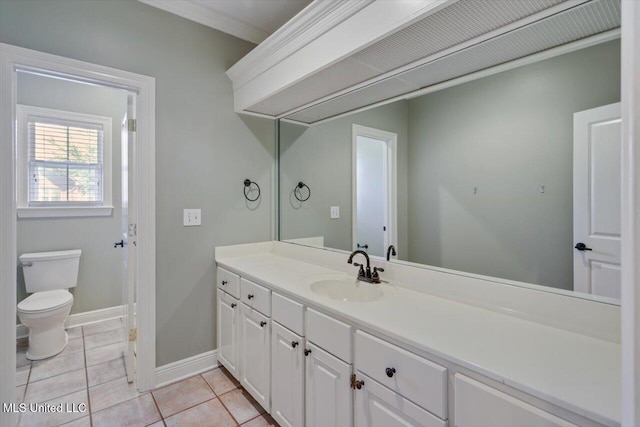 bathroom with tile patterned flooring, vanity, and toilet