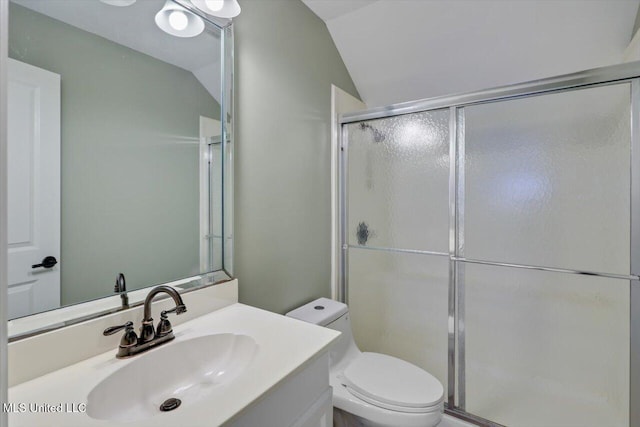 bathroom with vanity, toilet, lofted ceiling, and a shower with shower door